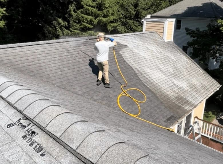 Twinsburg Power Washing professional cleaning and inspecting gutters on Twinsburg home