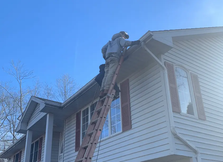 Gutter cleaning and maintenance being performed by Twinsburg Power Washing in Twinsburg